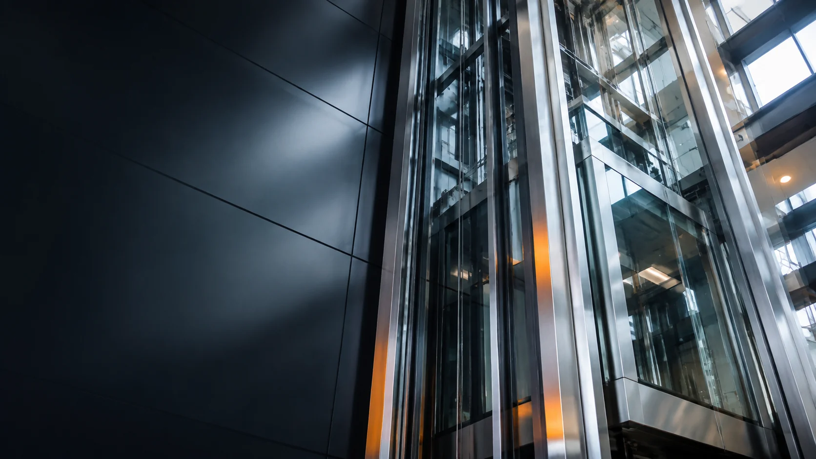 Modern glass elevator structure inside a commercial building